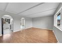 Bright living room with hardwood floors, arched doorways, and ample natural light from the large window at 2971 S Sheridan Blvd, Denver, CO 80227