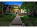 Charming brick home featuring an inviting walkway, manicured lawn and lovely front garden at 836 Steele St, Denver, CO 80206