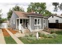 Inviting gray home featuring manicured landscaping and a quaint front entrance with steps at 2655 S Humboldt St, Denver, CO 80210