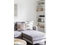 Cozy living room with a plush gray sofa, decorative pillows, and stylish built-in shelving at 2655 S Humboldt St, Denver, CO 80210