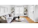 Bright living room featuring hardwood floors, a modern sofa, and built-in shelving at 2655 S Humboldt St, Denver, CO 80210