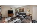 Inviting living room features a cozy fireplace, a large window, and comfortable seating at 6937 S Knolls Way, Centennial, CO 80122