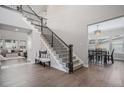Spacious foyer with staircase, wood floors and easy access to the dining room at 6733 S Waterloo Ct, Aurora, CO 80016