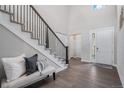 Inviting foyer featuring a staircase with iron railings and stylish decor at 6733 S Waterloo Ct, Aurora, CO 80016