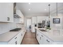 Modern kitchen featuring white cabinets, stainless steel appliances, and sleek countertops at 6733 S Waterloo Ct, Aurora, CO 80016