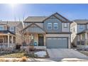 Two-story house with gray siding, landscaping, and a two-car garage at 15792 E Otero Cir, Centennial, CO 80112