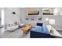 Bright living room with stylish furniture, gray rug, and decorative artwork at 2107 S Grant St, Denver, CO 80210