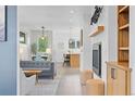 Open-concept living area with tile flooring, modern fireplace, comfortable seating, and natural light at 2107 S Grant St, Denver, CO 80210