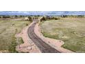 Scenic aerial view of a property showcasing a long driveway leading to a charming home nestled in a spacious landscape at 575 Heritage Trl, Elizabeth, CO 80107