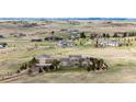 Beautifully landscaped property featuring a two-story home and detached garage on a sprawling lot in a serene neighborhood at 575 Heritage Trl, Elizabeth, CO 80107