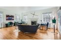 Bright living room with hardwood floors, large windows, and a cozy fireplace at 1788 Glencoe St, Denver, CO 80220