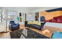 Bright living room with hardwood floors, modern art, and comfortable seating at 1788 Glencoe St, Denver, CO 80220