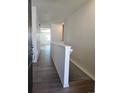 Bright hallway featuring hardwood floors and white walls leading towards other rooms at 6066 Caribou Dr, Brighton, CO 80601