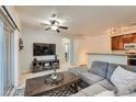 Inviting living room with a modern ceiling fan, neutral walls, and an abundance of natural light at 803 E 98Th Ave # 105, Thornton, CO 80229