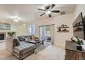 Spacious living room featuring stylish furnishings, fireplace, and a sliding glass door to a private patio at 803 E 98Th Ave # 105, Thornton, CO 80229