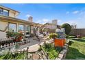 Outdoor patio featuring hanging swing chairs and manicured landscaping at 3191 S Holly Pl, Denver, CO 80222