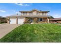 Charming two-story home with brick and siding exterior, manicured lawn and a two car garage at 3191 S Holly Pl, Denver, CO 80222