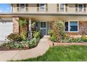 Inviting front entrance with beautiful flowers and well maintained landscaping at 3191 S Holly Pl, Denver, CO 80222