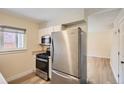 Efficient kitchen with stainless steel appliances, light cabinetry, and easy access to the living area at 8039 Wolff St # E, Westminster, CO 80031