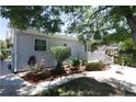 A well-maintained yard surrounds the light blue home, showcasing neat landscaping at 1455 W Alaska Pl, Denver, CO 80223