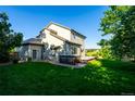Expansive backyard with a lush lawn, a hot tub, and a spacious wooden deck at 3232 Cimarron Pl, Superior, CO 80027