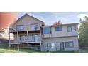 Rear exterior showcasing a two-story deck and fenced yard at 11323 E Cimmarron Dr, Englewood, CO 80111