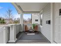 Inviting front porch with seating area, stylish decor, privacy and view of the front yard at 3057 S Fox St, Englewood, CO 80110
