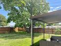 Spacious backyard with lush green grass and mature tree, great for outdoor living at 1701 W 50Th Ave, Denver, CO 80221