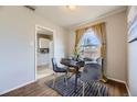 Cozy dining area featuring a stylish round table, seating for four, and natural light at 1701 W 50Th Ave, Denver, CO 80221