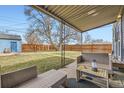 Covered patio with seating area, perfect for enjoying the outdoors year-round at 1701 W 50Th Ave, Denver, CO 80221