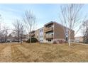 Apartment building featuring multiple levels of balconies and well-maintained landscaping at 1606 Cottonwood Dr # 24S, Louisville, CO 80027