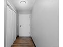 Hallway with wood floors, a front door, and a closet on the left at 1606 Cottonwood Dr # 24S, Louisville, CO 80027