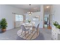 Cozy dining room with ample natural light, a modern chandelier, and seating for four at 12935 Lake Circle Dr, Thornton, CO 80241