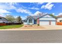 Charming single-Gathering home featuring a two-car garage and a beautifully landscaped front yard at 12935 Lake Circle Dr, Thornton, CO 80241