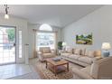 Bright living room featuring large windows, neutral decor, and comfortable seating at 12935 Lake Circle Dr, Thornton, CO 80241