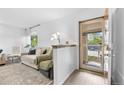 Bright living room featuring fresh white walls, modern decor, and a cozy seating arrangement by the door at 1490 S Salem Way, Aurora, CO 80012