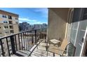 Condo balcony with black metal railing, seating, and cityscape views at 475 W 12Th Ave # 8H, Denver, CO 80204