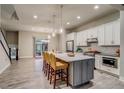 Spacious kitchen featuring a large island with seating and open layout to the living area at 5185 Vivian St, Wheat Ridge, CO 80033