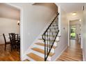 Elegant staircase with wood treads, decorative iron railing, and bright interior at 10366 E Ida Ave, Greenwood Village, CO 80111
