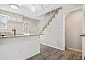 Modern kitchen with white cabinets, granite countertops, and a breakfast bar at 1811 S Quebec Way # 151, Denver, CO 80231