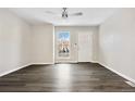 Bright living room featuring vinyl plank flooring and a large window at 1811 S Quebec Way # 151, Denver, CO 80231