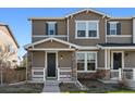 Two-story townhome featuring a well-maintained front yard and covered entry at 3011 Low Meadow Blvd, Castle Rock, CO 80109