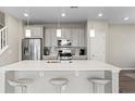 Bright kitchen featuring white countertops, an island with seating, and stainless steel appliances at 3011 Low Meadow Blvd, Castle Rock, CO 80109