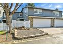 Inviting townhouse with a two-car garage, a well-kept lawn, and a cozy garden at 2879 S Xanadu Way, Aurora, CO 80014