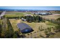 Aerial image showcasing a large building surrounded by trees, near city infrastructure, highlighting its natural and urban access at 12518 N Dixon Dr, Parker, CO 80138