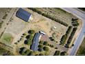 Aerial view of a property featuring multiple structures and landscaping, highlighting the layout and surrounding land at 12518 N Dixon Dr, Parker, CO 80138