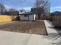 Large backyard featuring a detached garage, concrete patio, and gravel landscaping at 2000 Irving St, Denver, CO 80211