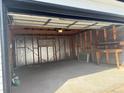 Interior view of a large, unfinished garage space with workbench at 2000 Irving St, Denver, CO 80211