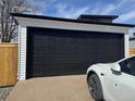 Spacious detached garage with a modern black door and adjacent parking at 2000 Irving St, Denver, CO 80211