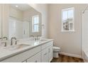 Well-lit bathroom featuring a double sink vanity, sleek fixtures, and a shower with tiled walls at 4978 Hickory Oaks St, Castle Rock, CO 80104